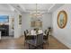 Elegant dining room with modern table, chairs, and decorative lighting at 712 Proud Eagle Ln, Las Vegas, NV 89144