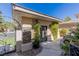 Charming exterior featuring a decorative wrought iron gate, stone accents, and manicured greenery at 712 Proud Eagle Ln, Las Vegas, NV 89144