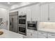 High-end kitchen appliances include a stainless steel refrigerator, double ovens, and microwave at 712 Proud Eagle Ln, Las Vegas, NV 89144