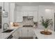 Updated kitchen features a modern faucet, stainless steel cooktop, and stylish cabinetry at 712 Proud Eagle Ln, Las Vegas, NV 89144