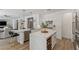 Modern kitchen with island, stainless steel appliances, and a breakfast bar seating area at 712 Proud Eagle Ln, Las Vegas, NV 89144