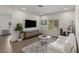 Cozy living area with hardwood floors, a comfortable white sofa, and a flat-screen TV at 712 Proud Eagle Ln, Las Vegas, NV 89144