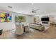 Bright living room featuring a modern fireplace, large TV, and comfortable seating area at 712 Proud Eagle Ln, Las Vegas, NV 89144