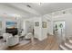 Spacious living room with hardwood floors, a piano, and ample seating, perfect for entertaining and relaxation at 712 Proud Eagle Ln, Las Vegas, NV 89144