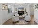 Bright sitting area with round rug, black piano, modern lighting, and white chairs at 712 Proud Eagle Ln, Las Vegas, NV 89144