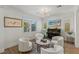 Bright sitting area with round rug, black piano, modern lighting, and white chairs at 712 Proud Eagle Ln, Las Vegas, NV 89144
