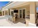 Outdoor kitchen area with bar seating, grill and tv, great for enjoying the pool at 712 Proud Eagle Ln, Las Vegas, NV 89144