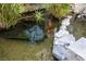 A tranquil pond with lush plantings and colorful koi creates a serene ambiance at 712 Proud Eagle Ln, Las Vegas, NV 89144