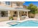 Gorgeous pool with spa and outdoor kitchen, complete with bar seating for entertaining guests at 712 Proud Eagle Ln, Las Vegas, NV 89144