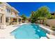 Gorgeous backyard pool with an outdoor kitchen, dining area, and mature landscaping at 712 Proud Eagle Ln, Las Vegas, NV 89144