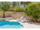 Lounge chairs, palm trees, and greenery adorn this tranquil pool side setting at 712 Proud Eagle Ln, Las Vegas, NV 89144