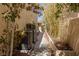 Landscaped side yard with mature trees and bushes, providing privacy and enhancing the property's curb appeal at 712 Proud Eagle Ln, Las Vegas, NV 89144