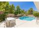 Resort-style swimming pool with a waterfall feature and ample seating space at 712 Proud Eagle Ln, Las Vegas, NV 89144