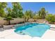 Sparkling swimming pool surrounded by mature trees and landscaping for privacy at 712 Proud Eagle Ln, Las Vegas, NV 89144