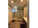 Modern bathroom with a large walk-in shower, neutral colors, and wood look floors at 740 Omaggio Pl, Henderson, NV 89011