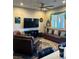 Comfortable living room featuring a ceiling fan, hardwood floors, a flat screen tv, and stylish decor at 740 Omaggio Pl, Henderson, NV 89011