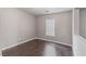Cozy bedroom with wood-look flooring, neutral paint, and a window for natural light at 776 Anacapri St, Las Vegas, NV 89138