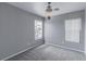Cozy bedroom features soft gray carpet, gray walls, and a decorative chandelier light fixture at 776 Anacapri St, Las Vegas, NV 89138