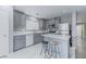 Modern kitchen with stainless steel appliances, quartz countertops, and a breakfast bar at 776 Anacapri St, Las Vegas, NV 89138