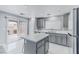 Updated kitchen featuring grey cabinets, quartz countertops, and a slider to patio at 776 Anacapri St, Las Vegas, NV 89138