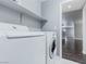 Laundry room featuring modern washer and dryer units plus shelving for organized storage at 776 Anacapri St, Las Vegas, NV 89138