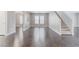 Large living area with wood-look flooring, staircase, and neutral paint at 776 Anacapri St, Las Vegas, NV 89138