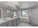 Main bathroom featuring double sinks, tub and glass shower at 776 Anacapri St, Las Vegas, NV 89138