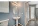 Cozy half-bathroom featuring a pedestal sink, and neutral color scheme at 8261 Golden Flowers St, Las Vegas, NV 89139