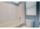Clean white bathroom with a tub and shower combination, toilet, and a window for natural light at 8261 Golden Flowers St, Las Vegas, NV 89139