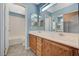 Ensuite bathroom features a double sink vanity, large mirror, and separate toilet room at 8261 Golden Flowers St, Las Vegas, NV 89139
