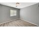 Comfortable bedroom with wood-look floors and a window providing natural light at 8261 Golden Flowers St, Las Vegas, NV 89139