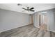 Bedroom with grey walls, wood-look flooring, ceiling fan and access to an ensuite bathroom at 8261 Golden Flowers St, Las Vegas, NV 89139