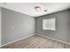 Bright bedroom with wood-look floors, a ceiling light, and a window providing natural light at 8261 Golden Flowers St, Las Vegas, NV 89139