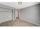 This bedroom has gray walls, wood-look floors, and a closet for storage at 8261 Golden Flowers St, Las Vegas, NV 89139