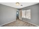 This bedroom has gray walls, wood-look floors, and a window for natural light at 8261 Golden Flowers St, Las Vegas, NV 89139