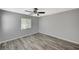 Cozy bedroom featuring wood-look flooring, a ceiling fan, and a window for natural light at 8261 Golden Flowers St, Las Vegas, NV 89139