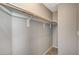 Walk-in closet with wood floors and wood rod for organizing clothing at 8261 Golden Flowers St, Las Vegas, NV 89139