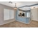 View of the dining area leading to the kitchen with breakfast bar and white cabinets at 8261 Golden Flowers St, Las Vegas, NV 89139