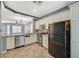 Functional kitchen with white cabinets and appliances, including a black refrigerator at 8261 Golden Flowers St, Las Vegas, NV 89139