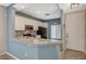 Well-lit kitchen with granite counters, white cabinets and black appliances at 8261 Golden Flowers St, Las Vegas, NV 89139