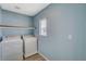 Dedicated laundry room with a window, built-in shelf and washer and dryer at 8261 Golden Flowers St, Las Vegas, NV 89139
