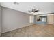 Spacious living area with neutral paint, tile flooring, and view of kitchen at 8261 Golden Flowers St, Las Vegas, NV 89139