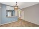 Bright living room with neutral walls, tile flooring, and open access to the kitchen area at 8261 Golden Flowers St, Las Vegas, NV 89139