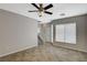 Spacious living area featuring a neutral paint palette, tiled floors, staircase, and natural light at 8261 Golden Flowers St, Las Vegas, NV 89139