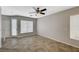 Spacious living room with tile flooring, neutral walls, and ample natural light from large windows at 8261 Golden Flowers St, Las Vegas, NV 89139