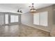 Bright, open living room featuring tile floors, neutral paint, and stylish lighting at 8261 Golden Flowers St, Las Vegas, NV 89139