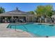 Relaxing community pool area with comfortable lounge chairs and clear blue water at 8261 Golden Flowers St, Las Vegas, NV 89139