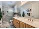 Bright bathroom featuring a double sink vanity, walk-in shower with glass door, and modern fixtures at 8325 Villa De Medici St, Las Vegas, NV 89131