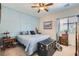 Comfortable bedroom with a blue accent wall, cozy bedding, and ample natural light at 8325 Villa De Medici St, Las Vegas, NV 89131