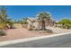 Beautiful landscaped front yard with a palm tree, desert landscaping and gated RV or boat parking at 8325 Villa De Medici St, Las Vegas, NV 89131
